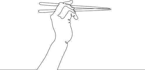 The hand holds chopsticks. Asian traditional cutlery.One continuous line drawing. Line Art isolated white background.