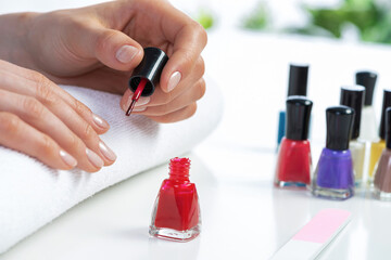 Wall Mural - Woman giving herself elegant manicure at home