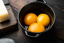 Bright Yellow Egg Yolks, On Old Dark  Wooden Table