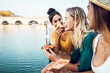 © Xavier Lorenzo - Diverse young women friends eating italian take away pizza in city street - Multiracial female having fun together on summer vacation - Copy space for text