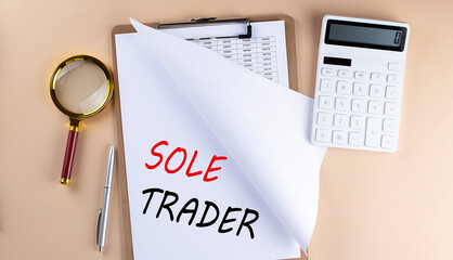 Poster - Clipboard with chart and text SOLE TRADER with magnifier ,calculator on beige background