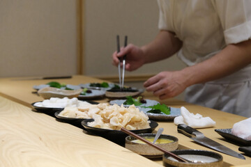 Close up of a chef preparing japanese dish for the eater at a japanese restaurant.