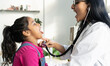 © PintoArt - Indian female doctor examining a cute little girl with a stethoscope - auscultating child -