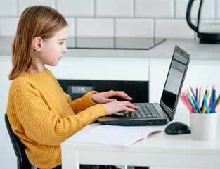 Preteen girl with laptop