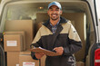 © Adene Sanchez/peopleimages.com - Deliveries are right on schedule. Portrait of a smiling delivery man standing in front of his van holding a package.