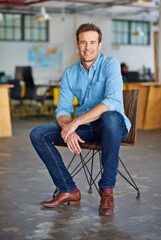 Poster - Designing my perfect career. Portrait of a handsome young designer sitting on a chair in an office.