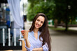 © fotofrol - Portrait of young woman sitting in a cafe outdoor drinking coffee