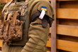 A military man holds a medical tourniquet in his hands to stop blood in first aid and prevent bleeding. Combat tactical equipment. Combat use Turnstile.