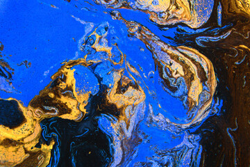 Beautiful abstract background. Golden and dark blue mixed acrylic paints. Abstract ocean- ART. Natural Luxury. Stones like marble contain all the history and secrets of the Earth.