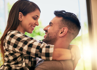 Canvas Print - My heart melts when I look into your eyes. Shot of an affectionate young couple bonding at home.