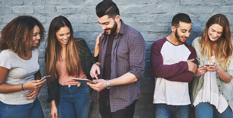 Aufkleber - Good friends and a great wifi connection. Shot of a group of young friends using their wireless devices together outdoors.