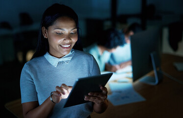 Poster - Whatever the night has in store, shell handle it. Shot of a young businesswoman using a digital tablet during a late night at work.