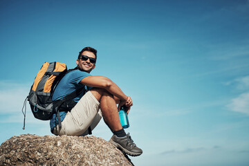 Poster - Look at this amazing view. Portrait of a carefree young man taking a quick break from hiking up a mountain during the day.