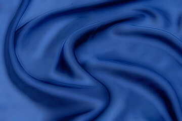Wall Mural - Close-up texture of natural blue fabric or cloth in same color. Fabric texture of natural cotton, silk or wool, or linen textile material. Blue canvas background.
