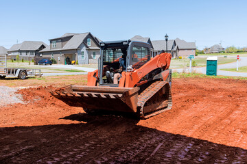 Earth moving by bulldozer at work with during landscaping works the territory improvement