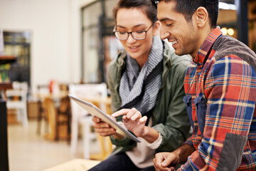 Poster - Technology makes planning their evening easy. Cropped shot of a young couple using a digital tablet together.