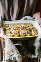 Cannelloni with mushroom stew and chestnuts. Author's Corsican cuisine. Cannelloni in a baking dish