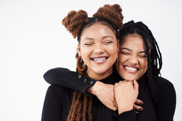Aufkleber - Smiling lights up the face. Studio shot of two beautiful young women posing against a grey background.