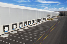 A Large New Logistics Complex. The View From The Outside. Places For Trucks To Unload, Warehouse Docks.