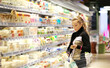 © lado2016 - Woman choosing a dairy products at supermarket