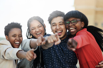 Sticker - We want you. Portrait of a group of happy students pointing toward the camera.