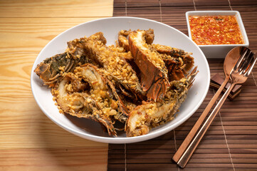 Sticker - Stir fried flathead lobster with garlic and pepper on wooden table, Fried flathead lobster with garlic.