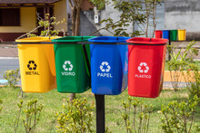 Set Of Bins For The Selective Collection Of Waste (metal, Glass, Paper, And Plastic), In Portuguese,  For Recycling Purposes.