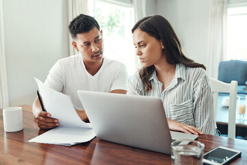 Aufkleber - Its a numbers game. Cropped shot of a young couple using a laptop to their household budget in the living room at home.