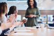 © Adene Sanchez/peopleimages.com - She deserves all the praise in the world. Low angle shot of a group of businesspeople applauding a colleague while sitting in the boardroom during a meeting.