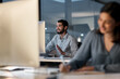 © Nicholas Felix/peopleimages.com - Creating happy customers is a 247 commitment. Shot of a young man using a headset and computer late at night in a modern office.