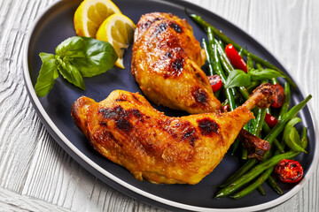 Wall Mural - juicy roast chicken legs with green beans salad