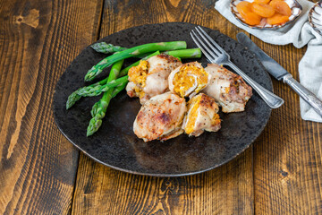 Canvas Print - Chicken thighs with appricot stuffing and asparagus