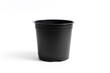 © Maria - small black plastic pot for indoor flowers on a white background. accessories for seedlings of plants at home.