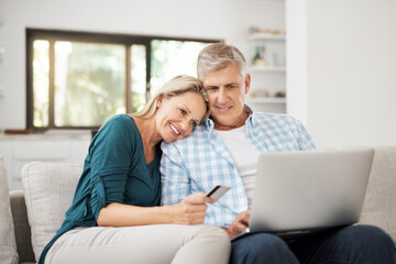 Poster - So...what are we buying today. Cropped shot of an affectionate mature couple using their laptop to do some online shopping at home.