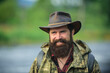 © Volodymyr - Portrait of traveller bearded man in cowboy hat. Close up portrait of happy middle aged smiling man in a countryside.