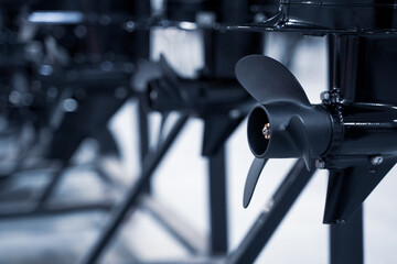 closeup of row of black boat ship propellers