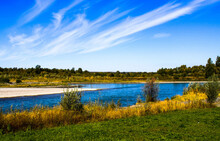 Blue River, Yellow And Green Grass, Green Trees On A Background Of The Blue Sky, Siberia