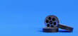 3d render of reel film isolated on blue background.