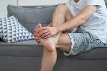 Foot Pain, Man Suffering From Feet Ache At Home