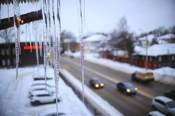 Wall Mural - icicles on the roof urban background view winter city