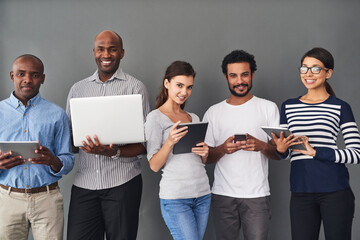 Aufkleber - Theres a gadget for all your needs. Studio shot of businesspeople using wireless technology against a gray background.