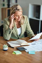 Poster - Racking her brain. High angle shot of a mature businesswoman looking thoughtful while working in her corporate office.