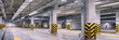 Empty shopping mall underground parking lot or garage interior with concrete stripe painted columns