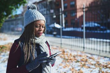 Aufkleber - Status update Winter is here. Shot of a beautiful young woman using a mobile phone on a snowy day outdoors.