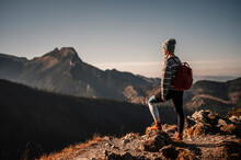 Traveler Hiking  With Backpacks. Hiking In Mountains. Sunny Landscape. Tourist Traveler On Background View Mockup. High Tatras , Poland