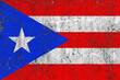 Flag of puerto rico on a damaged old concrete wall