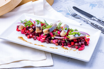 Wall Mural - Vinaigrette with herring and red onion on a white plate