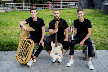 Young street music band play a lot of musical instruments