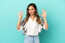 Young Woman Over Isolated Blue Background Counting Nine With Fingers