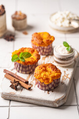 Wall Mural - Sweet homemade cottage cheese muffins with pumpkin on white background